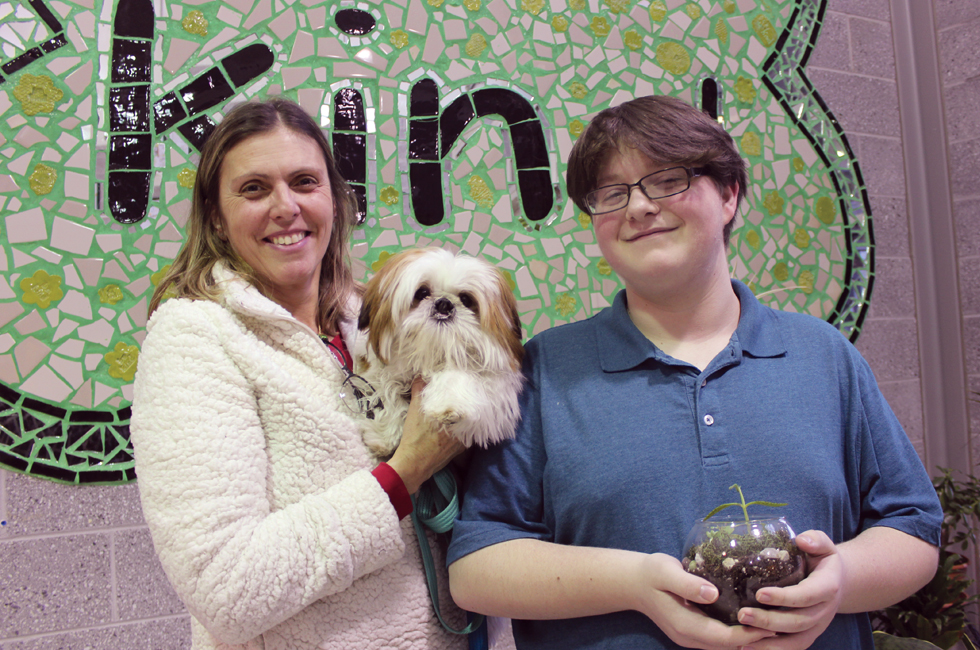An image of student Aidan with social worker Toni and dog Leo
