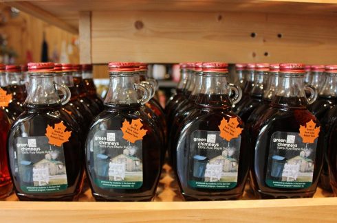 This image shows bottles of maple syrup made by Green Chimneys students are one of our store's most popular items.
