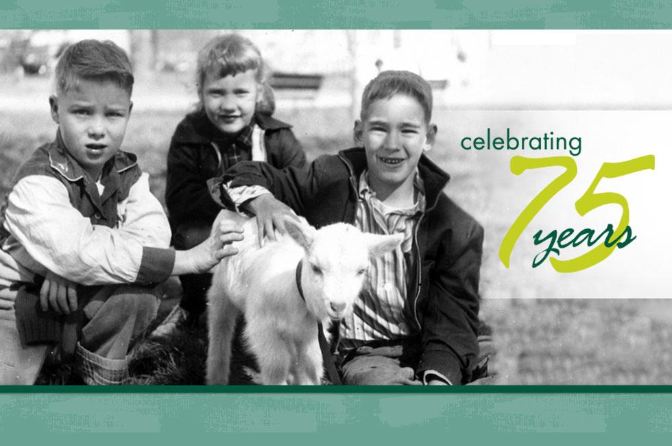 black and white image shows three children with a lamb. The words "Celebrating 75 Years" appears on the right side of the image.