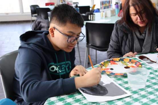 Student paints part of a Amanda Gorman mural