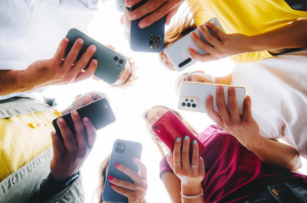 Representation of a group of teens each using a smartphone